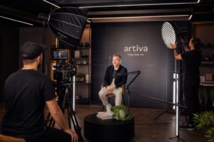 Videographer filming professional brand video in a studio
