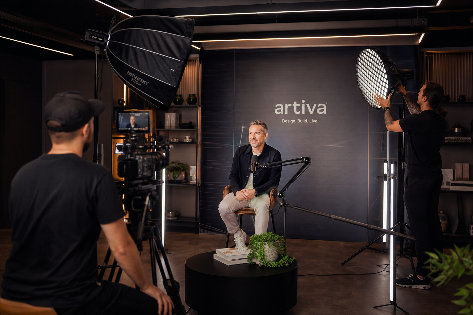 Videographer filming professional brand video in a studio
